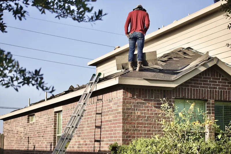 Professional roofer working on a residential roof in Barnesville